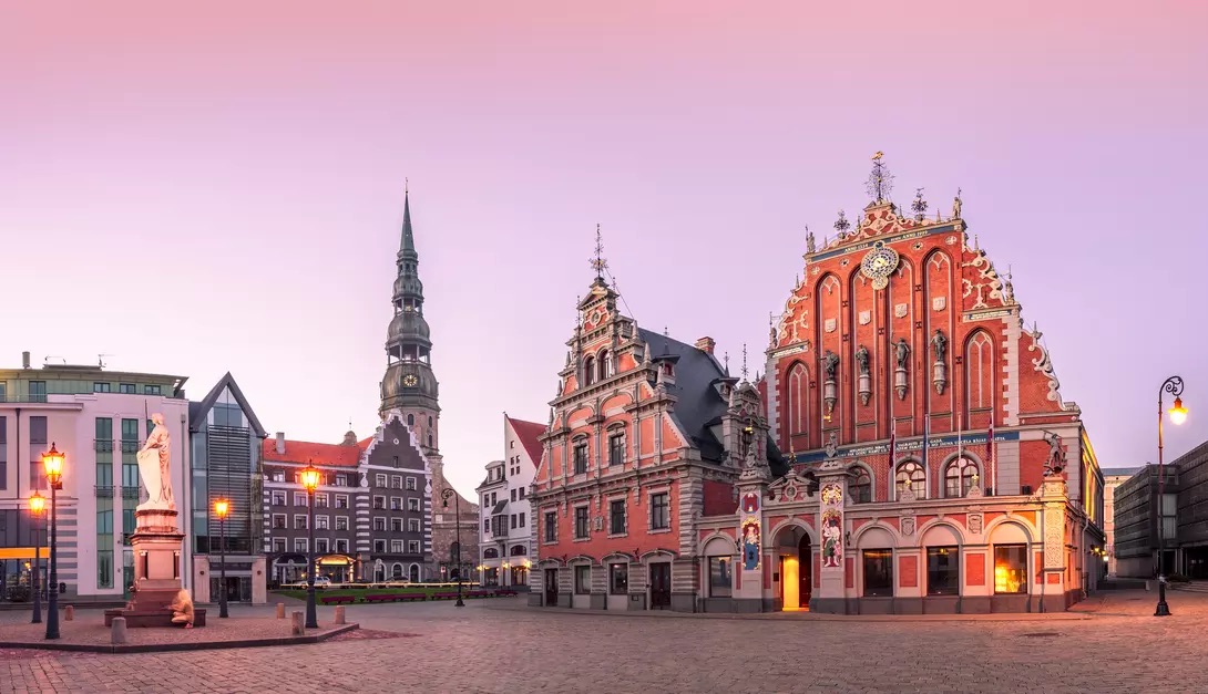 A vibrant view of Riga's old town square, showcasing its charming architecture and lively atmosphere filled with people.