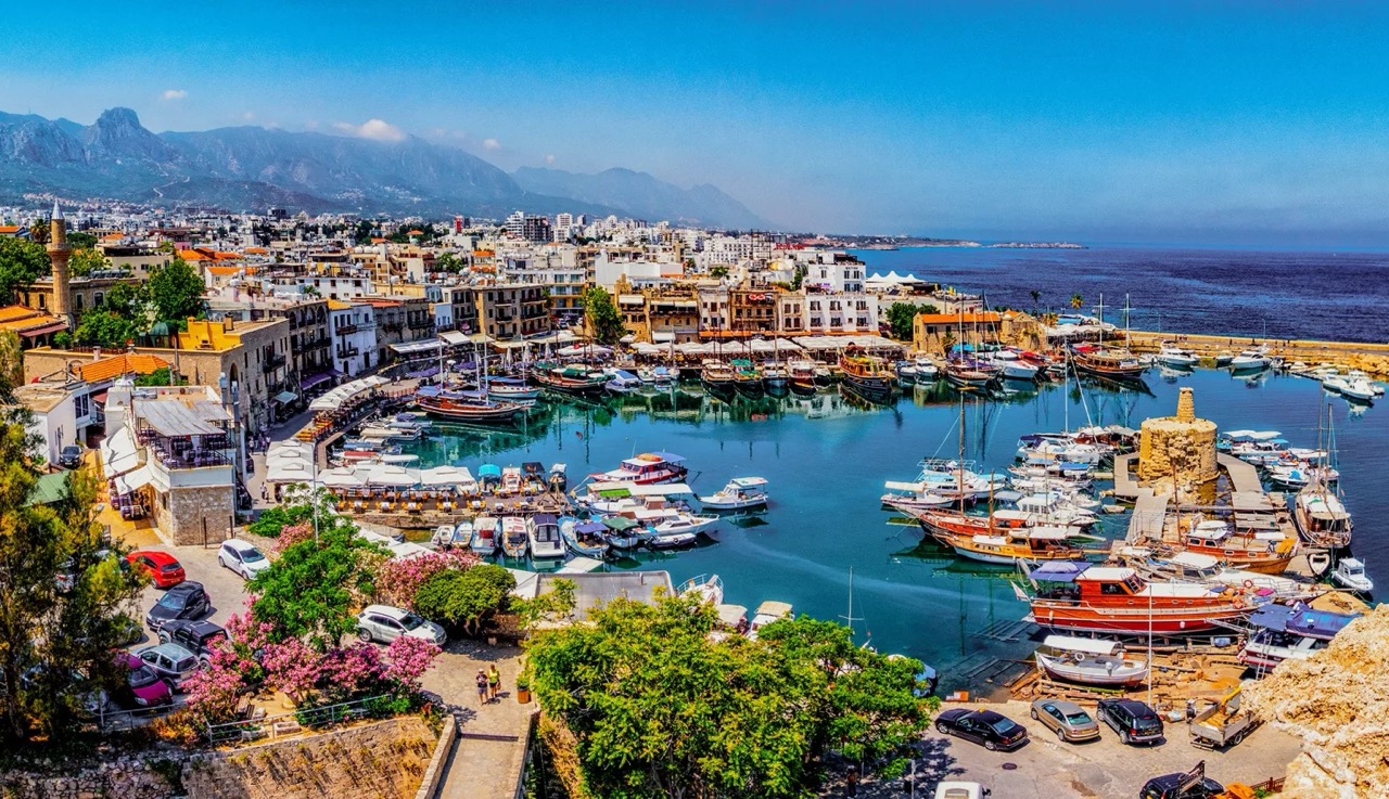 A high-angle, vibrant panoramic view of the historic Kyrenia Old Harbour in Cyprus