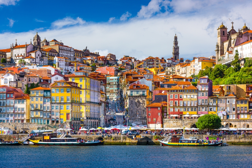 The image is of the historic Ribeira district in Porto, Portugal, viewed from across the Douro River